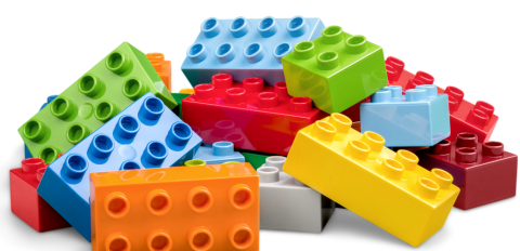 Yellow, orange, blue, red and green Lego building blocks in a pile