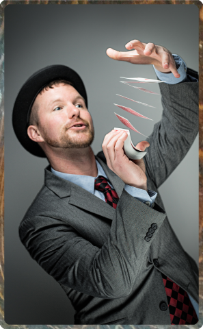 Man in a suit and hat with magic cards